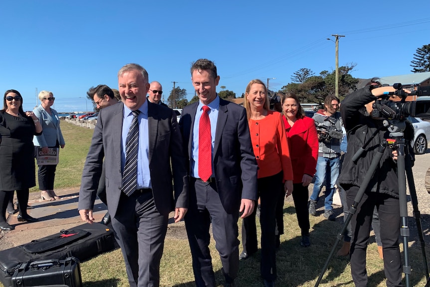 Group of people in suits walking, including federal labor leader Anthony Albanese and member for Cunningham Sharon Bird.