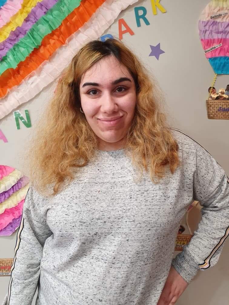 Merna Aprem smiles while posing for a portrait.