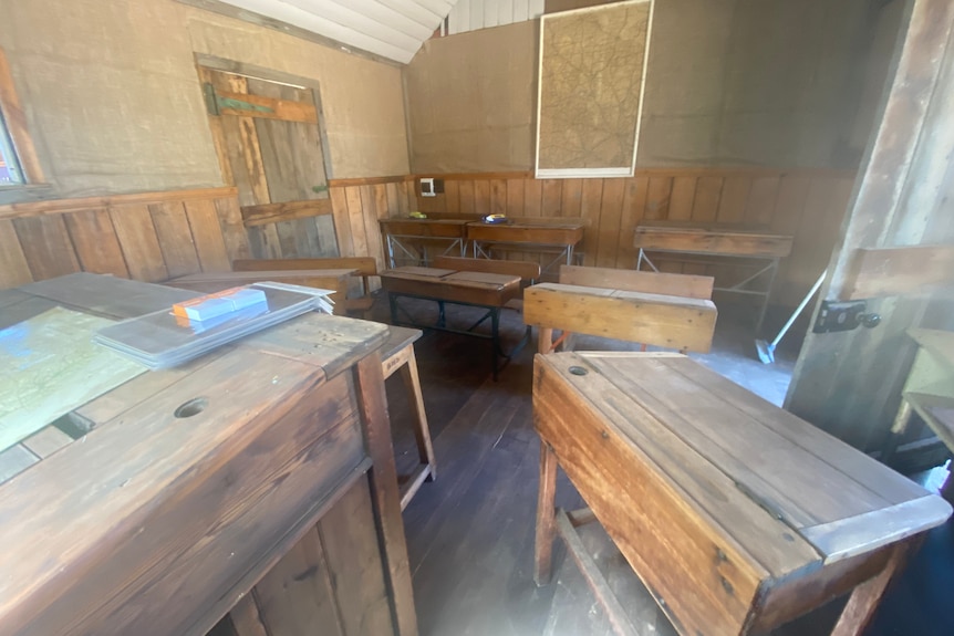 an old goldrush classroom, boring wooden desks