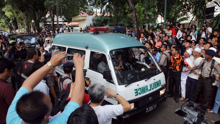 Hundreds of people packed the sides of the street, which has been closed to traffic since news of his death.