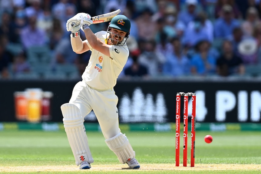 Travis Head watches the ball fly away after completing a cover drive