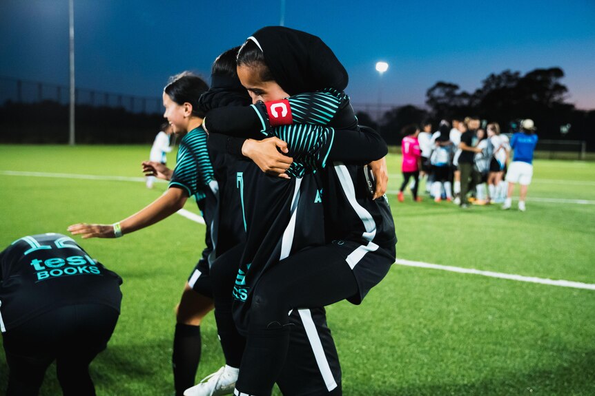 Footballers hug