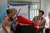 Eva Lawler and Cheng Jingye revealing a plaque