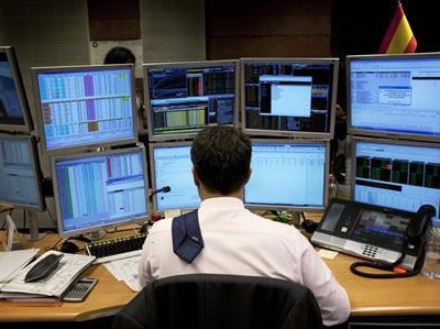 A trader looks at  a screen during a bond auction.