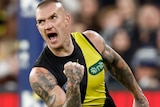 Dustin Martin pumps his fist and yells in delight