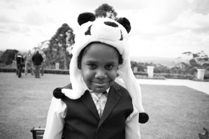 Black and white photo of Charlie Chambers as a boy, wearing a panda hat.