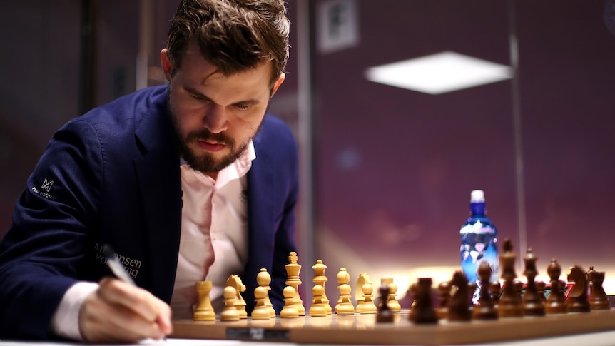 Magnus Carlsen of Norway strategizing to make his next move while playing a game of chess
