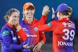 Alice Capsey, Meg Lanning and Jess Jonassen celebrate a wicket for the Delhi Capitals in the Women's Premier League.