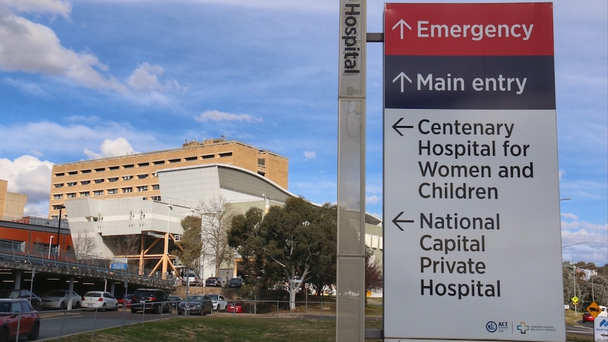 A sign directing to the emergency department in front of a hospital.