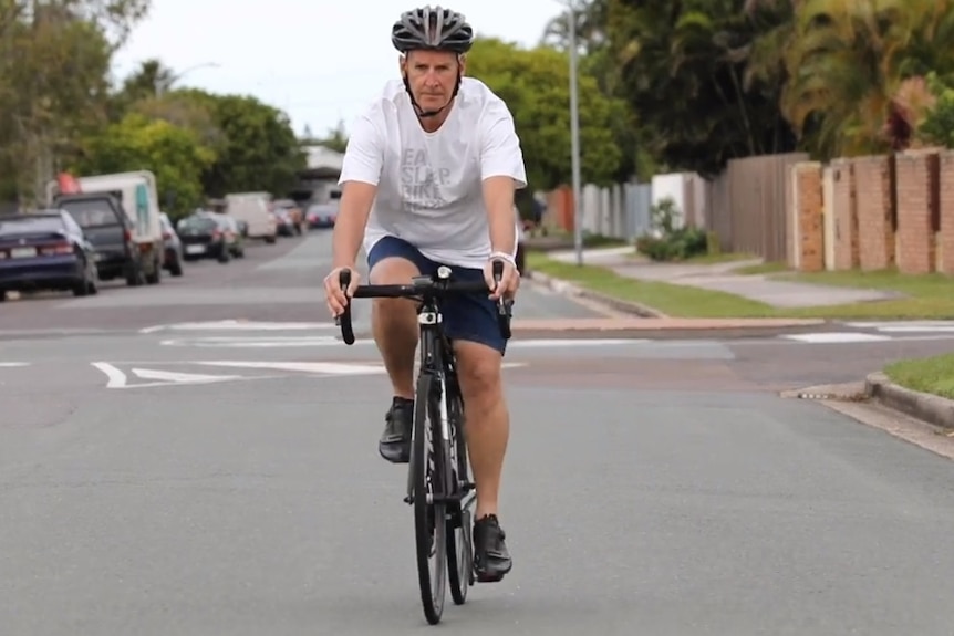 Cyclist riding his bike on a road.