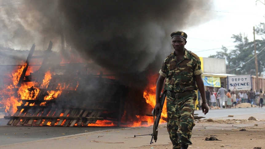 A soldier walks past a barricade in Bujumbura