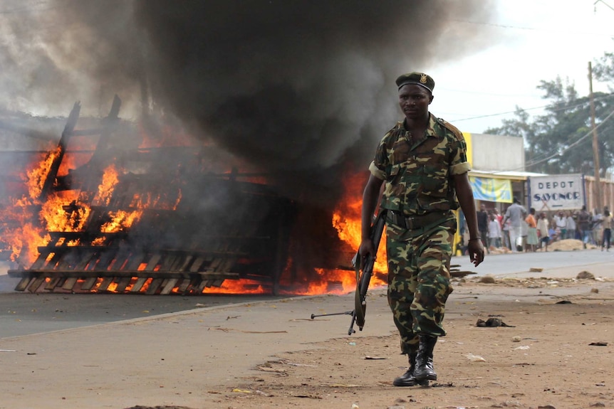 A soldier walks past a barricade in Bujumbura