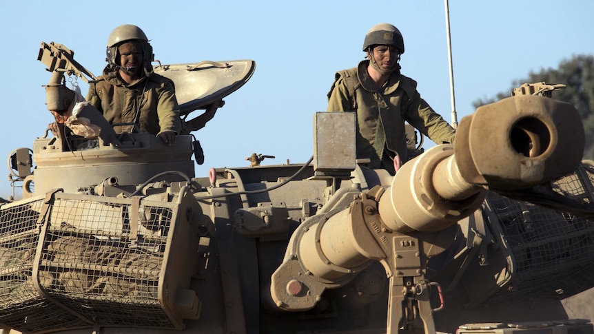 Israeli soldiers drive through sandy terrain during a military exercise in the Israeli-occupied Golan Heights.