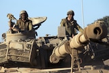 Israeli soldiers drive through sandy terrain during a military exercise in the Israeli-occupied Golan Heights.