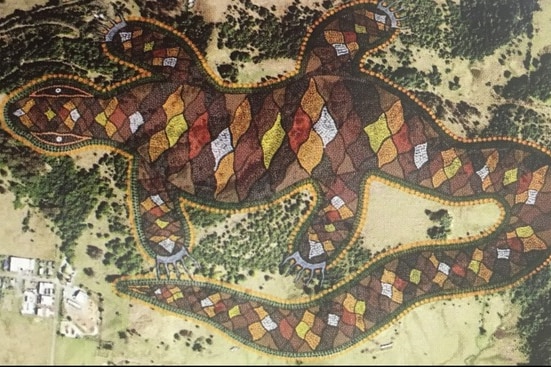 An Aboriginal-style goanna drawing over an aerial shot of trees and grassland