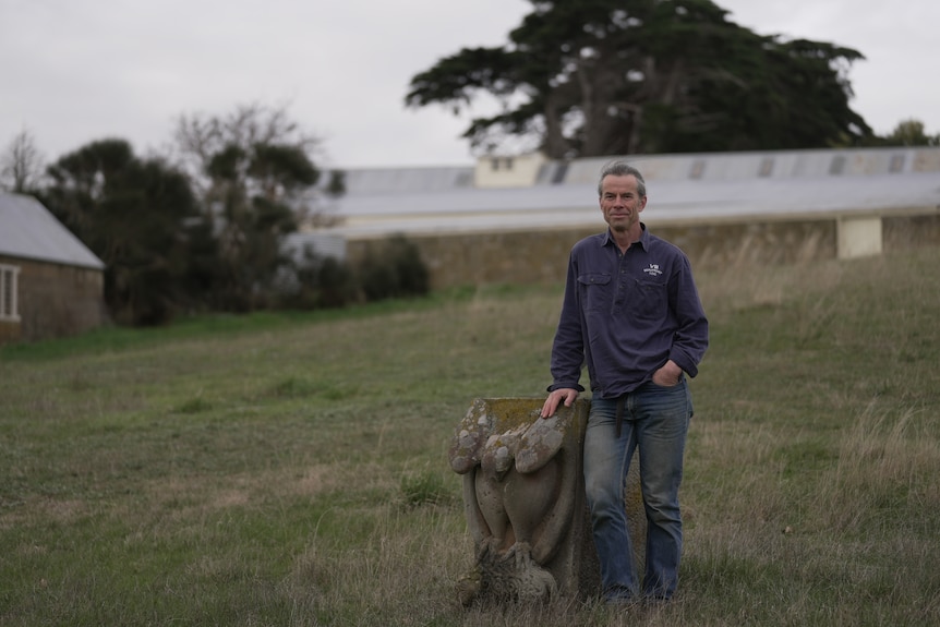 Man standing in a field on his farm.