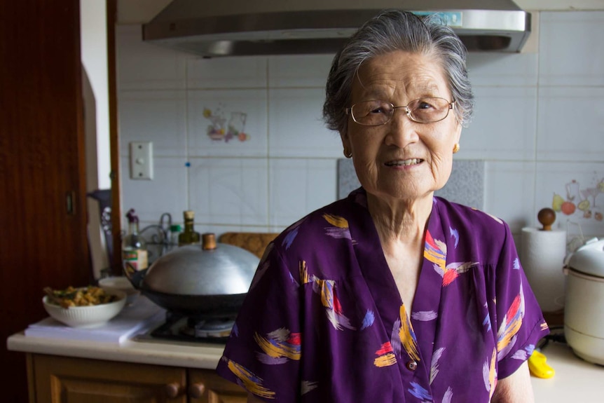 Kwee Lian Tan stands in her kitchen