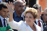 Brazil's suspended President Dilma Rousseff waves to supporters.