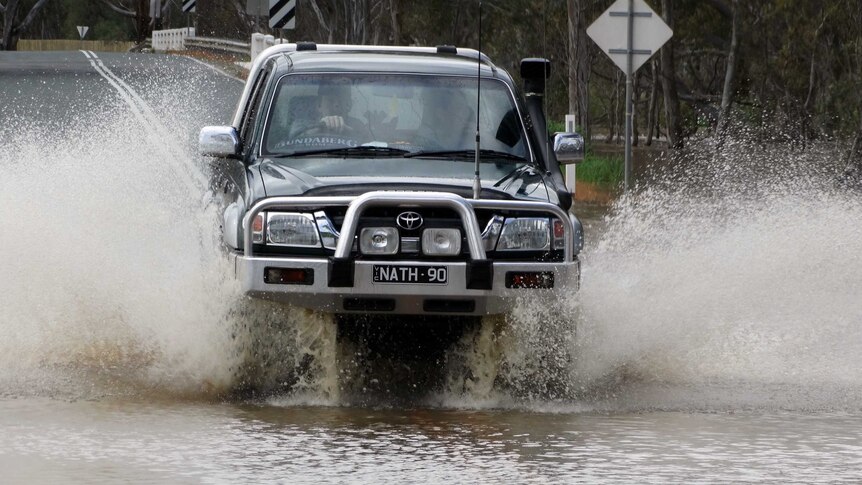 A four-wheel drive navigates through floodwaters in Charlton.
