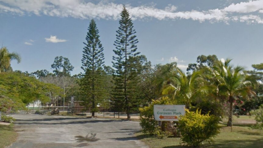 The driveway and sign for Calliope Caravan Park.