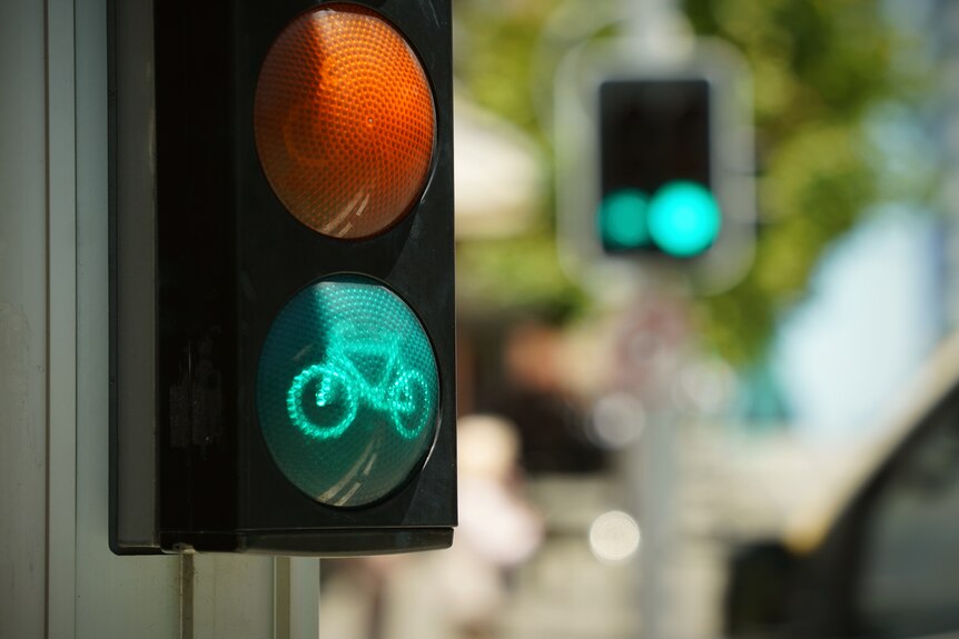 A green traffic light for cyclists at a street intersection