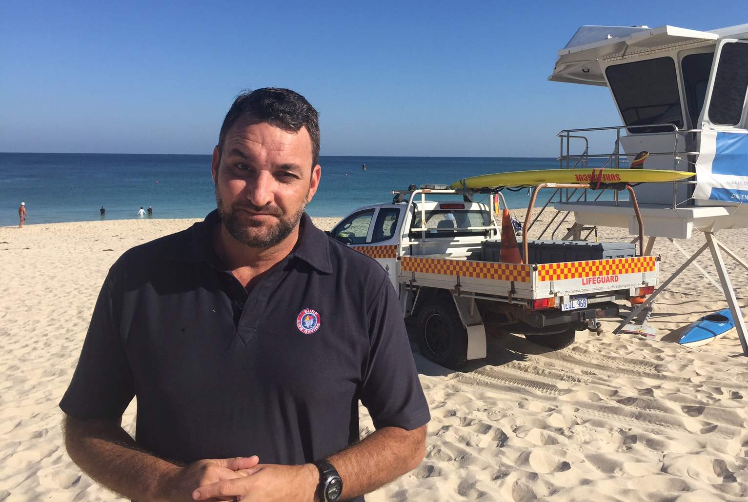 General manager Surf Life Saving WA Chris Peck standing at the beach with the ocean in the background.