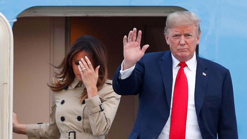 Donald and Melania Trump disembark a plane.