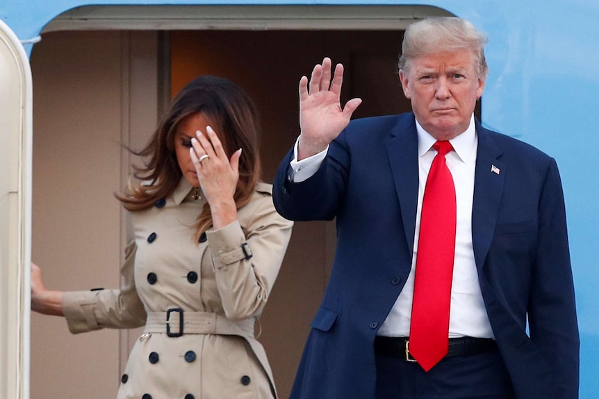 Donald and Melania Trump disembark a plane.