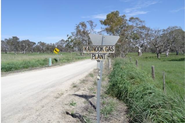 A sign reads 'Katnook Gas Plant' with a dirt road and scrub in the background.