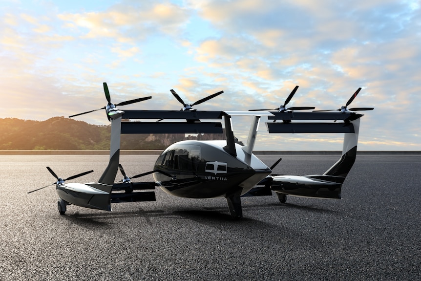 A rendered image of an electric aircraft on tarmac with the sun setting in the distance