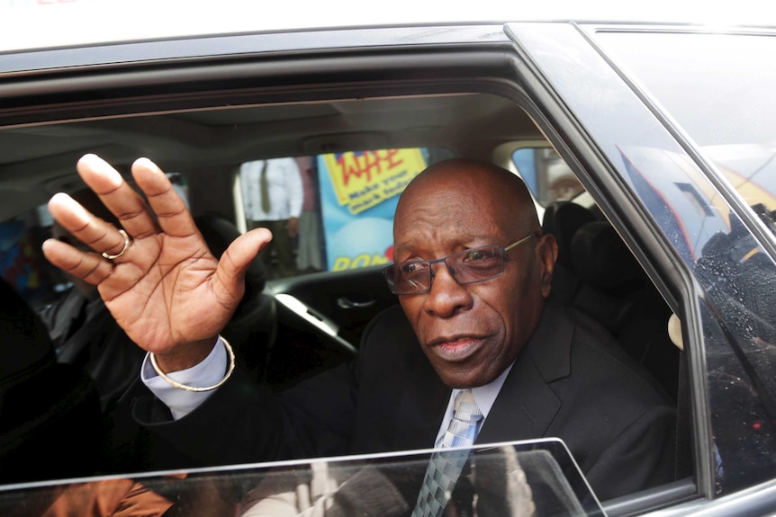 Former FIFA vice-president Jack Warner waves from car after leaving court in Trinidad in July 2015.
