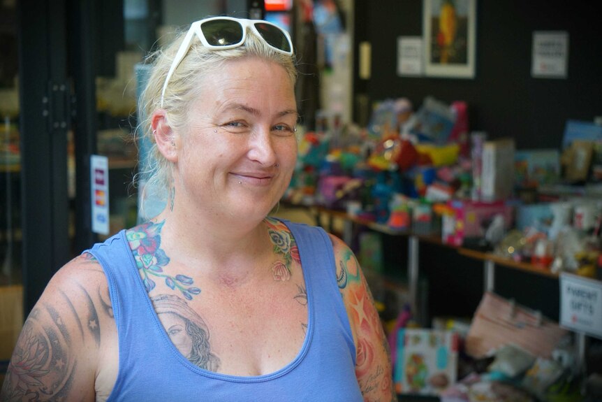 A woman with glasses stands in a Salvation Army centre