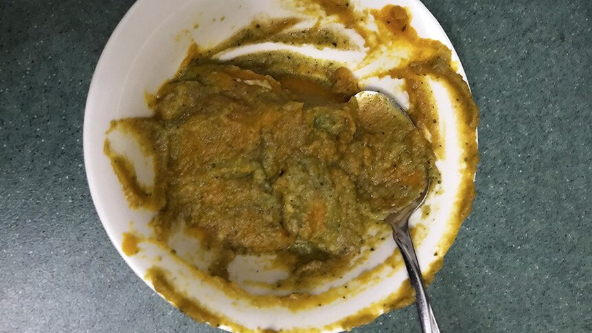 Brown and green puree in a bowl.