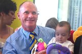 Campbell Newman meets some babies in Caboolture on Monday.