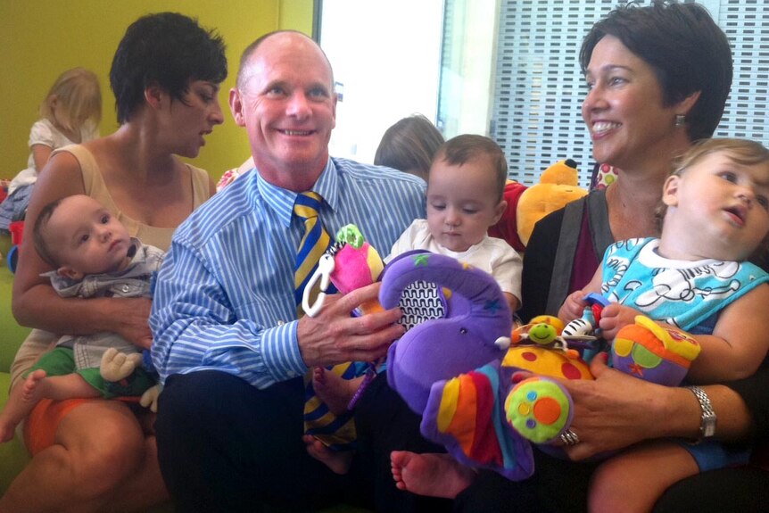 Campbell Newman meets some babies in Caboolture on Monday.