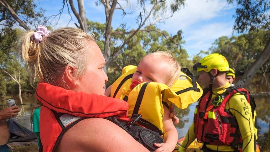 a mother and baby in emergency life jackets