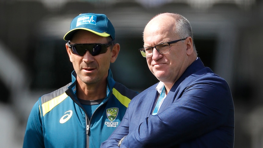 Justin Langer and Earl Eddings stand next to each other.