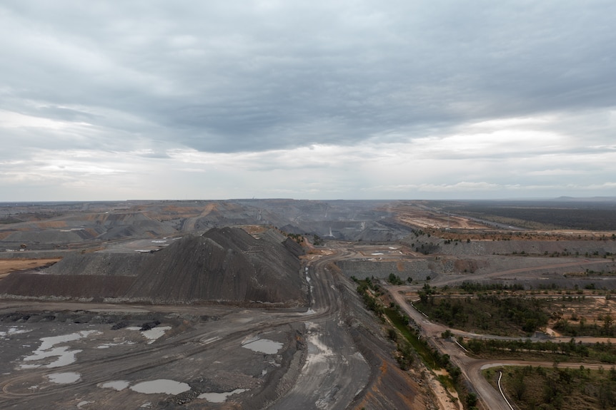 An aerial photo of a mining pit and waste piles at Goonyella Riverside mine near Moranbah, November 2021.