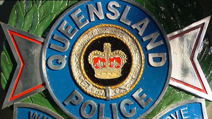 TV still of Qld Police emblem sign logo on an office wall