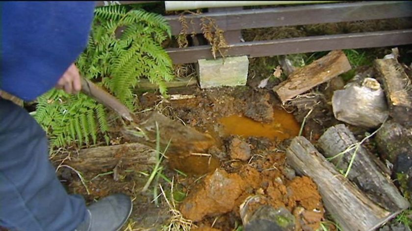 Orange water in a drain at a Rosebery home, Tasmania.