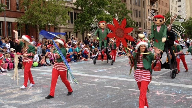Elves smile and wave at the crowd