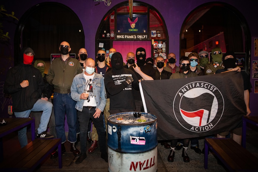 The crowd photo at a heavy metal gig. They are holding an anti-fascist flag. 