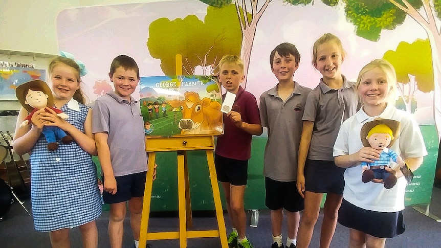 Students from Ouyen College with some of the books and toys marketed through the fictional character 'George the Farmer'.