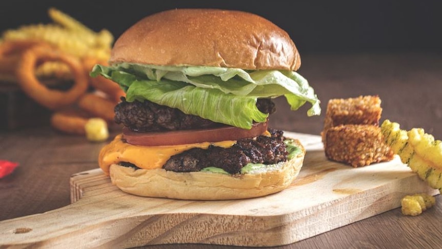 Photo of a hamburger on a chopping board 