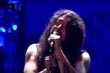 Dave Grohl crying on stage as he sings into the microphone