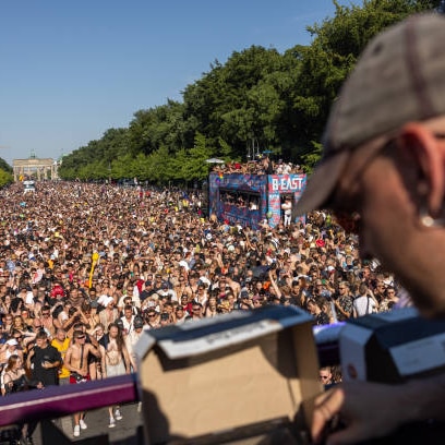 Thousands throng the boulevard leading up to the Brandenburg Gate, as part of the Rave The Planet festival in Berlin 
