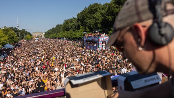 Thousands throng the boulevard leading up to the Brandenburg Gate, as part of the Rave The Planet festival in Berlin 