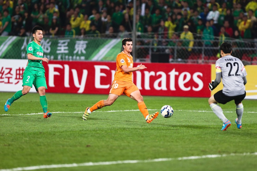 Andrija Kaluderovic takes on the Beijing Guoan defence