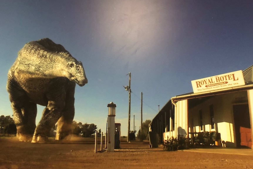 A superimposed image of a large dinosaur towers over Eromanga's Royal Hotel.