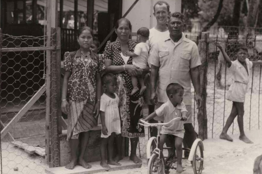 Tom Meigan with Head Boatman, Sakmat and his family outside their house on Home Island, Cocos Islands